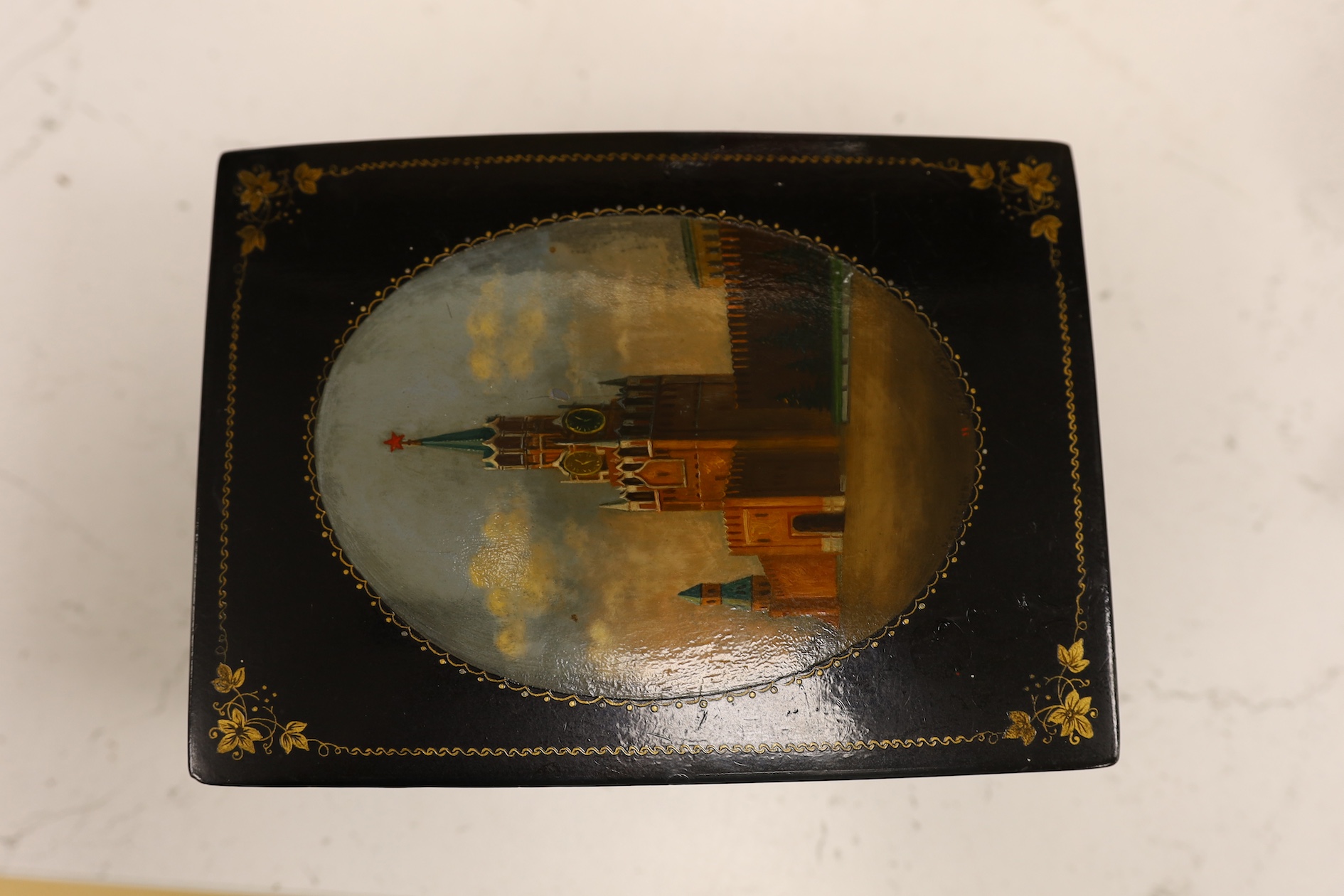 A Russian lacquer box, probably Fedoskino, 11.5cm wide x 15.5cm deep x 5cm high. Condition - some damage one side, fine overall marks